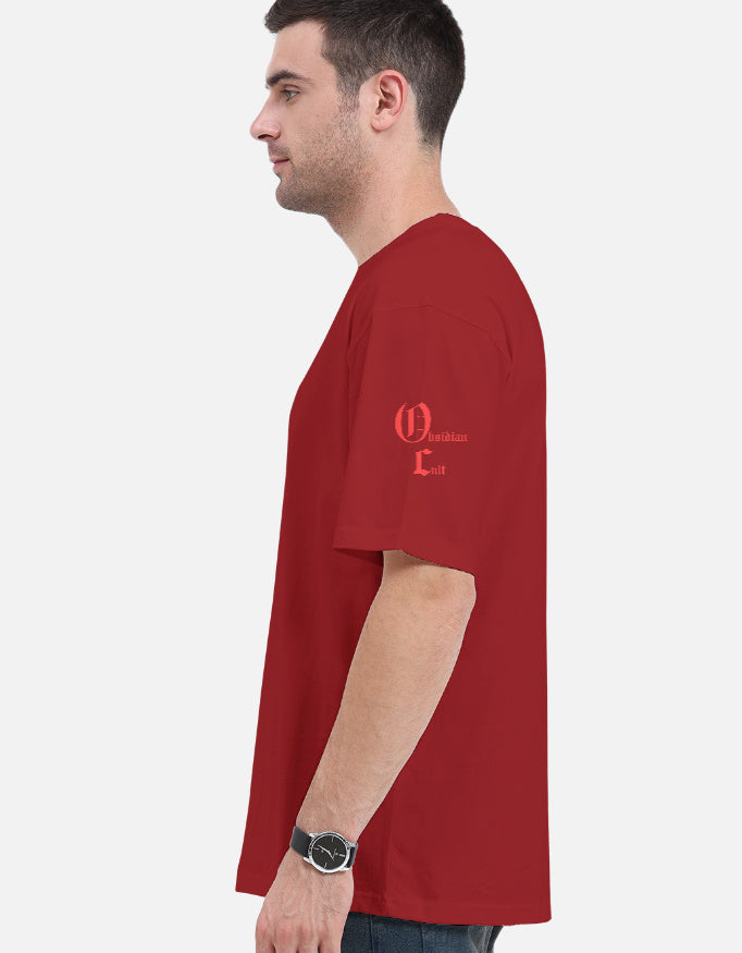 Side view of a man wearing a red t-shirt with 'Obsidian Cult' text printed on the sleeve against a white background