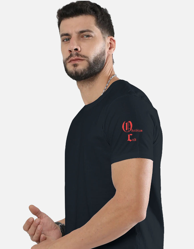 Man wearing black t-shirt with red Obsidian Cult logo on left sleeve, posing against white background
