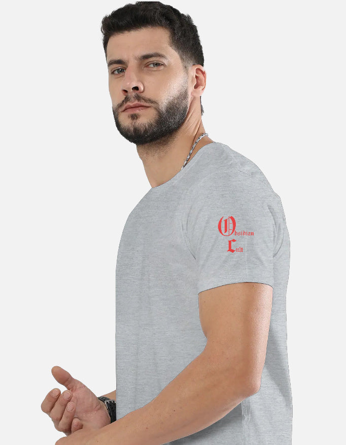 Man wearing light gray t-shirt with red Obsidian Cult logo on left shoulder against white background