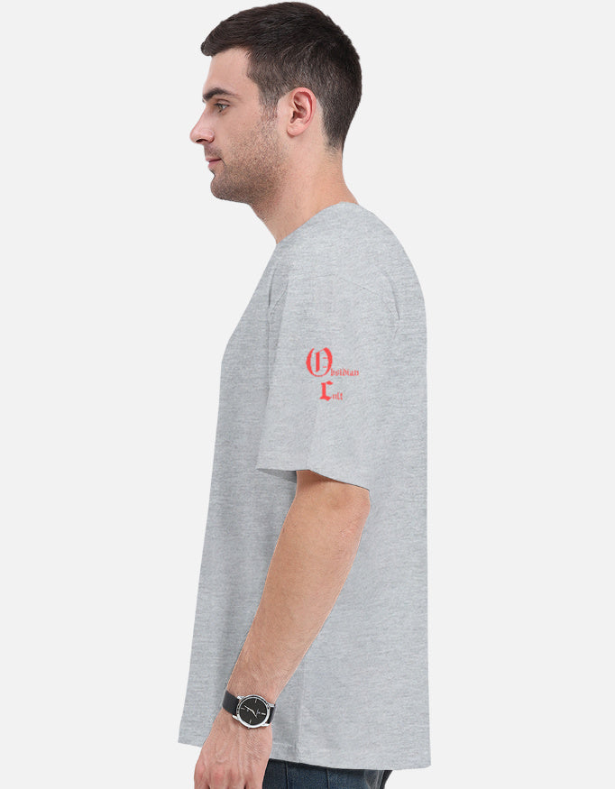 Side profile of man wearing light gray t-shirt with red 'Christian Cult' text on left sleeve