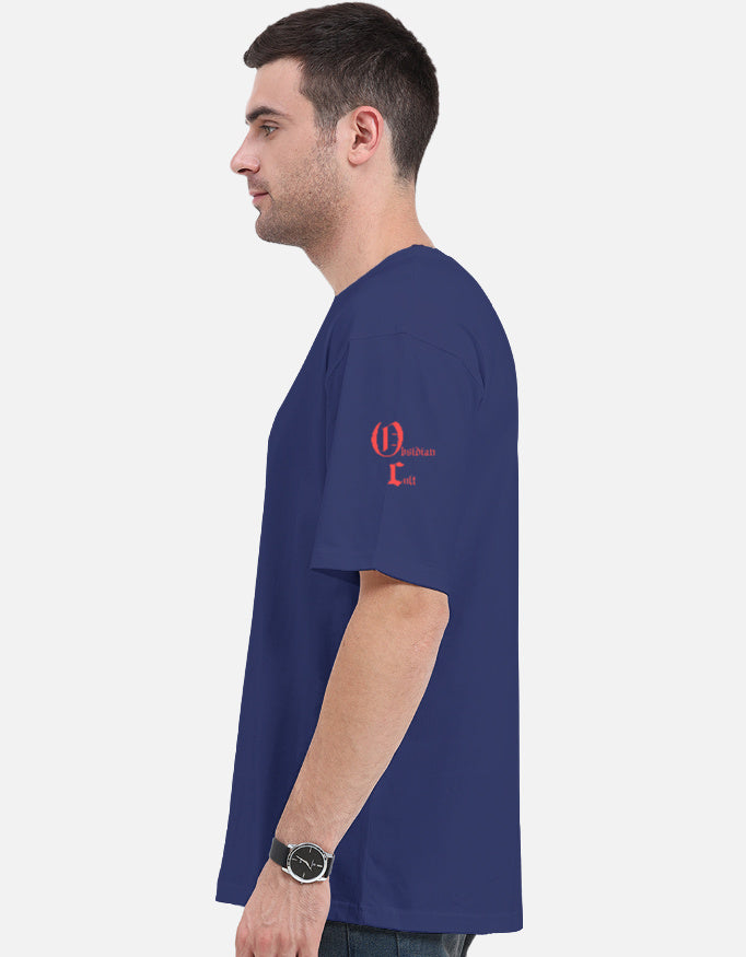 Side view of man wearing navy blue t-shirt with red Gothic text on left sleeve, white background